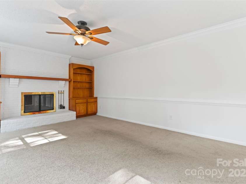 9833 White Cascade Drive, Charlotte, NC 28269.  MLS# CAR4275187, YatesRealty ID 27475. Family room with wood burning fireplace