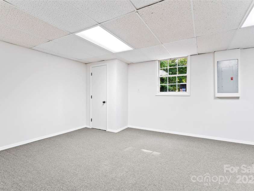 9833 White Cascade Drive, Charlotte, NC 28269.  MLS# CAR4275187, YatesRealty ID 27475. Large finished room in basement