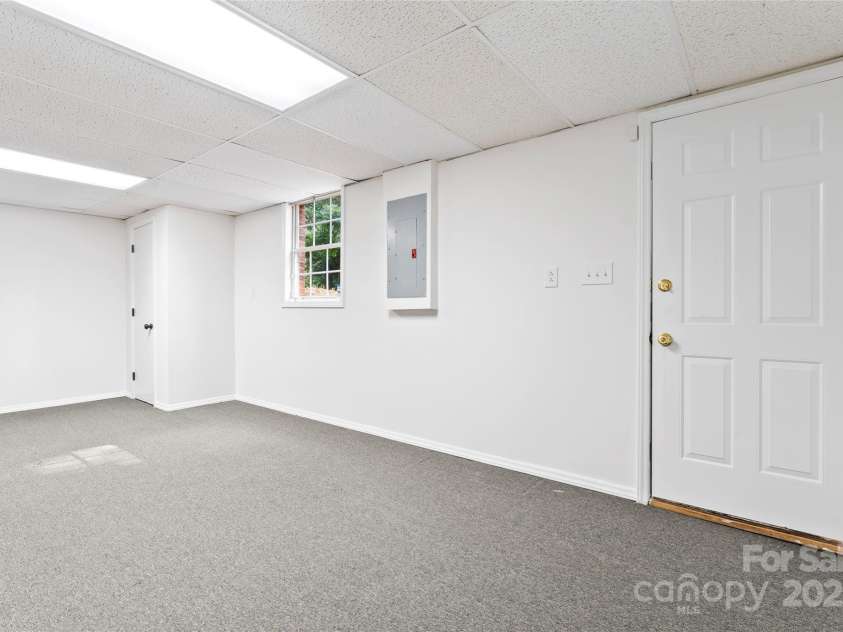 9833 White Cascade Drive, Charlotte, NC 28269.  MLS# CAR4275187, YatesRealty ID 27475. Large finished room in basement with outside entrance