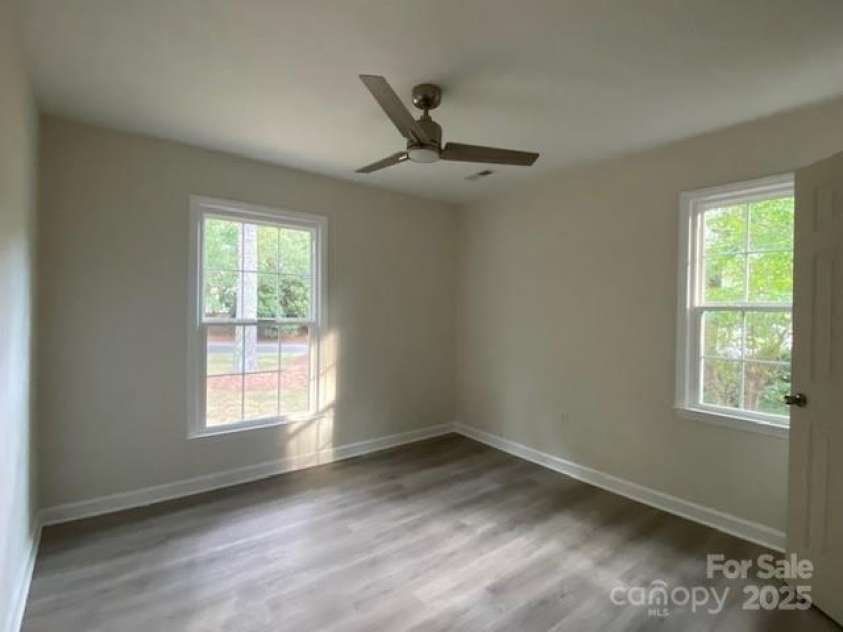709 Falls Church Road, Charlotte, NC 28270.  MLS# CAR4275080, YatesRealty ID 27488. Bedroom 1, LVL flooring, nice fan with LED lighting