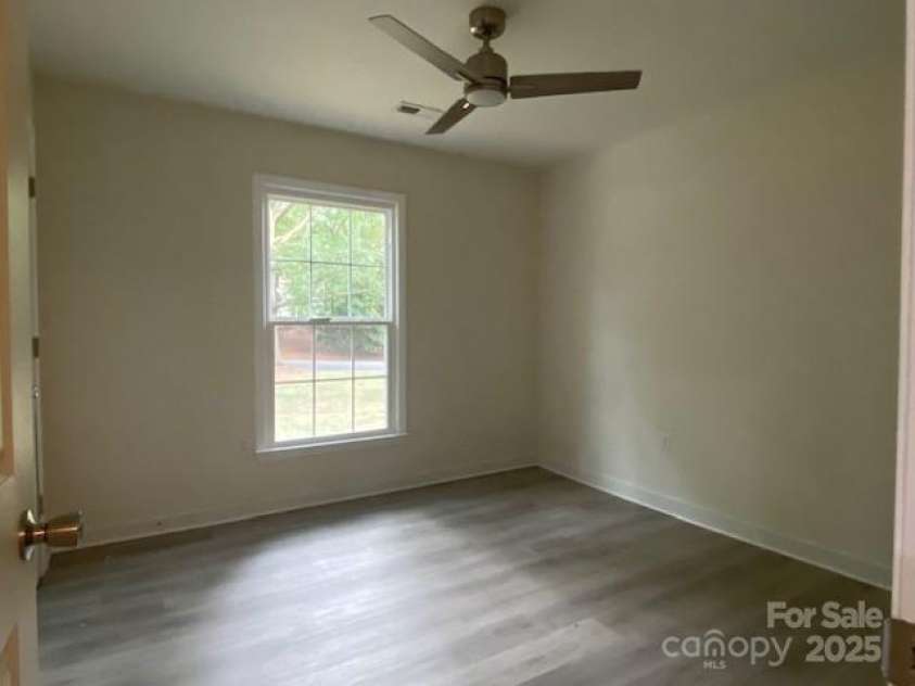 709 Falls Church Road, Charlotte, NC 28270.  MLS# CAR4275080, YatesRealty ID 27488. Bedroom 2, LVL flooring, nice fan with LED lighting