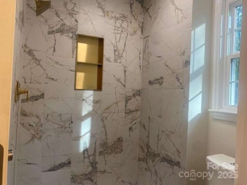 709 Falls Church Road, Charlotte, NC 28270.  MLS# CAR4275080, YatesRealty ID 27488. Primary Bath Shower with modern tile and niche.