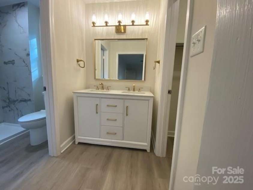 709 Falls Church Road, Charlotte, NC 28270.  MLS# CAR4275080, YatesRealty ID 27488. Primary Bath with double sinks and dimmer light