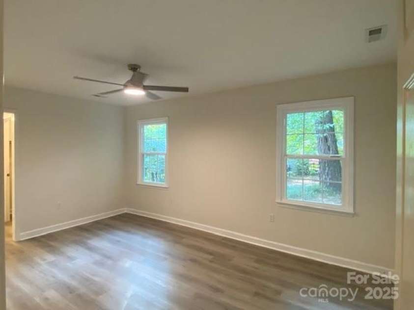 709 Falls Church Road, Charlotte, NC 28270.  MLS# CAR4275080, YatesRealty ID 27488. Primary Bedroom 3, LVL flooring, nice fan with fan with LED lighting
