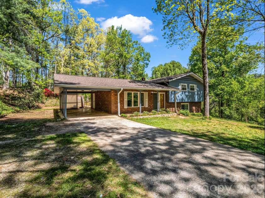 31 Firefly Lane, Saluda, NC 28773.  MLS# CAR4370921, YatesRealty ID 27498. Carport and side yard