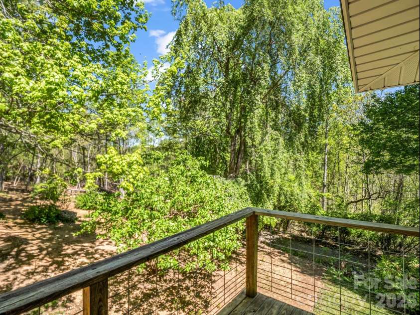 31 Firefly Lane, Saluda, NC 28773.  MLS# CAR4370921, YatesRealty ID 27498. Main Bedroom deck over looking expansive back yard