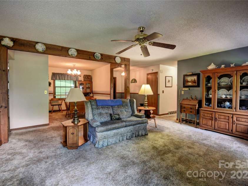 501 Locust Grove Drive, Waynesville, NC 28785.  MLS# CAR4282099, YatesRealty ID 27527. Another photo of the living/ dining areas