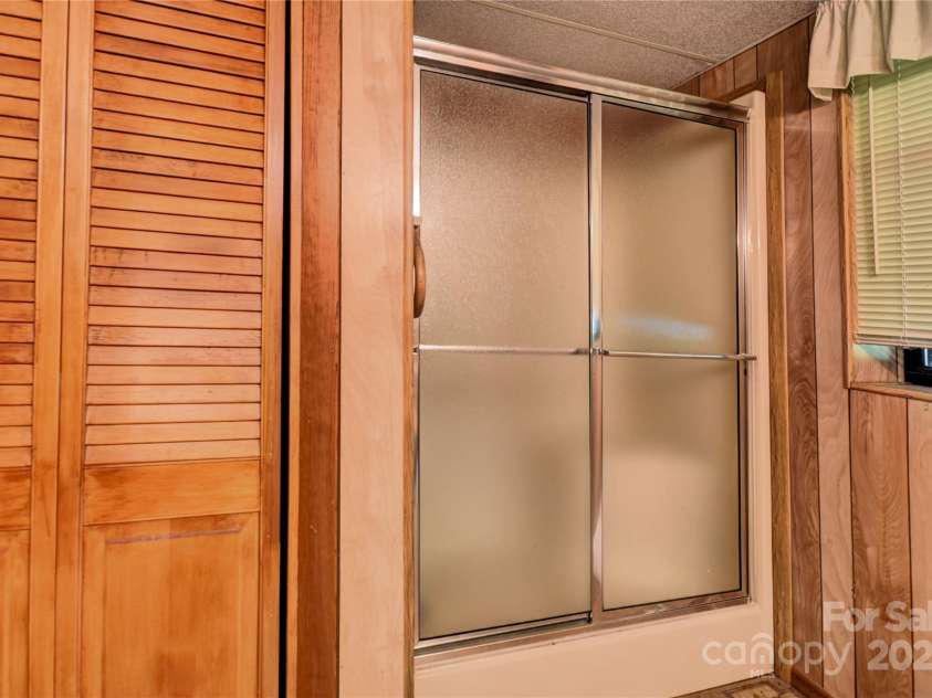 501 Locust Grove Drive, Waynesville, NC 28785.  MLS# CAR4282099, YatesRealty ID 27527. Closet and Shower in the basement bath