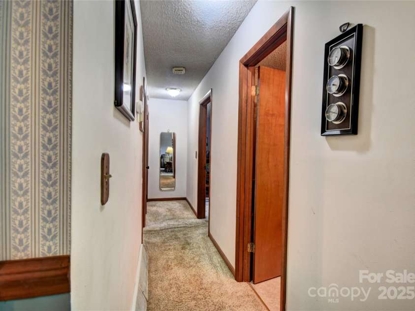 501 Locust Grove Drive, Waynesville, NC 28785.  MLS# CAR4282099, YatesRealty ID 27527. Hallway to the bedroom area