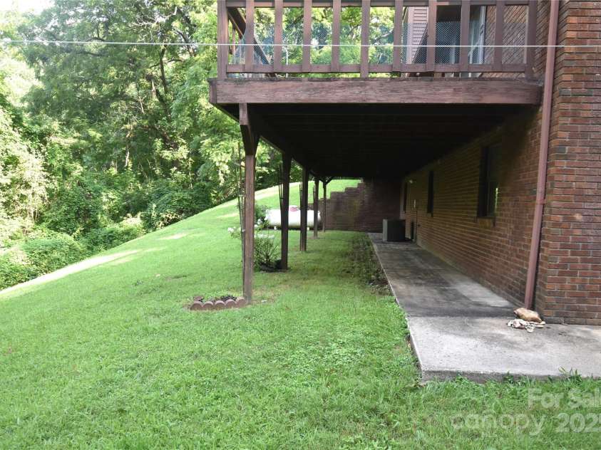 501 Locust Grove Drive, Waynesville, NC 28785.  MLS# CAR4282099, YatesRealty ID 27527. Large deck in the rear of the home
