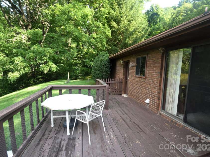 501 Locust Grove Drive, Waynesville, NC 28785.  MLS# CAR4282099, YatesRealty ID 27527. Sliding glass door from the living area to the deck, also a rear exit from the double garage