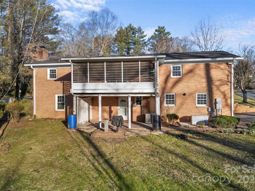 123 Castleton Lane, Hendersonville, NC 28791.  MLS# CAR4237756, YatesRealty ID 2754. Back of home/ screened porch & patio