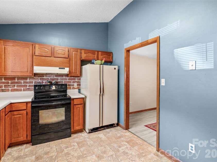 1404 Wellington Hills Circle, Salisbury, NC 28147.  MLS# CAR4383791, YatesRealty ID 27540. Kitchen leading to dining area.