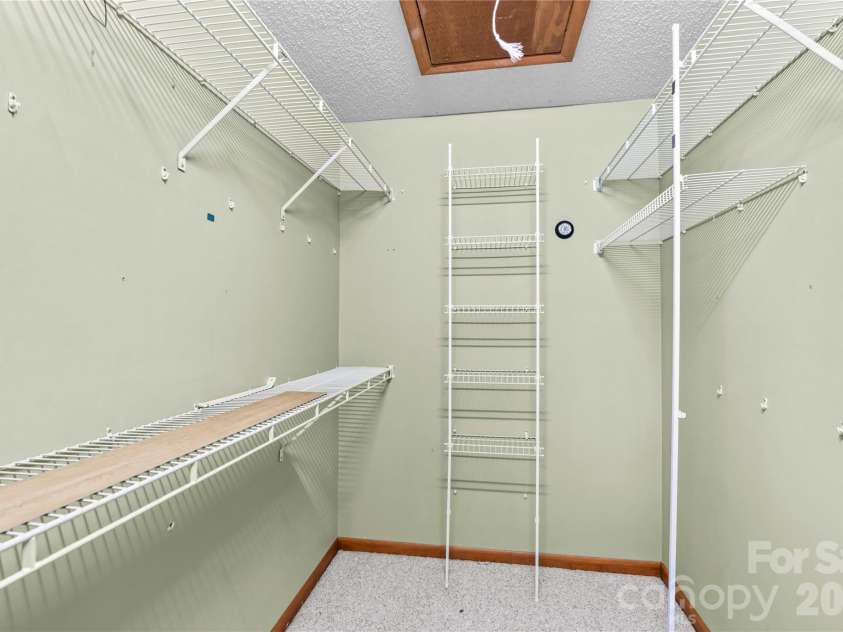 1404 Wellington Hills Circle, Salisbury, NC 28147.  MLS# CAR4383791, YatesRealty ID 27540. Large primary WIC with drop down attic with storage.