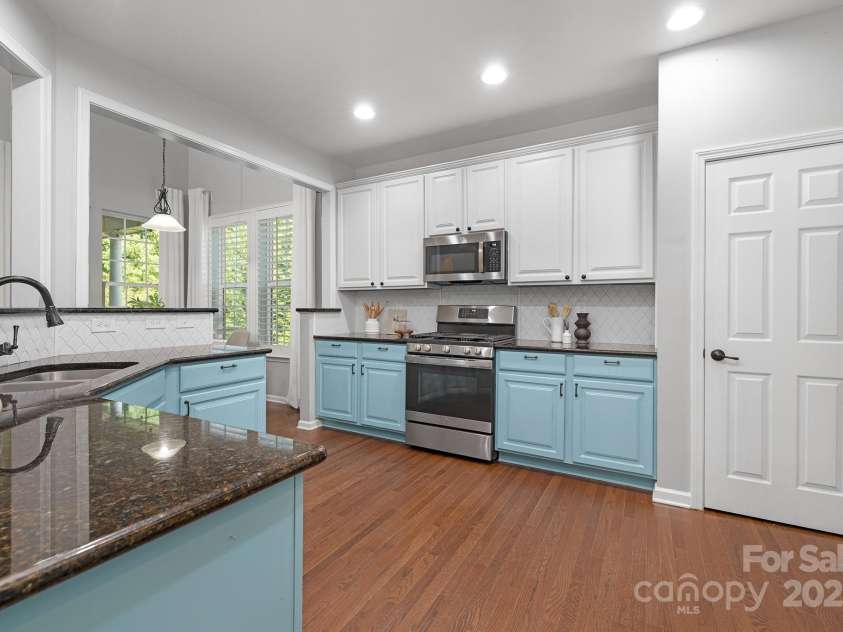 446 Leaf Arbor Court, Clover, SC 29710.  MLS# CAR4281228, YatesRealty ID 27544. Kitchen offers painted cabinets, backsplash, pantry, and recent appliances.