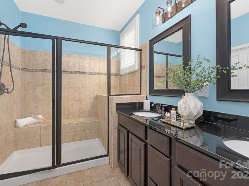 446 Leaf Arbor Court, Clover, SC 29710.  MLS# CAR4281228, YatesRealty ID 27544. Primary bath with large shower, double vanity, and walk in closet.