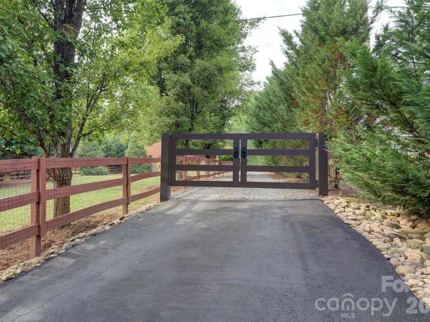 15425 Rocky River Road, Davidson, NC 28036.  MLS# CAR4382327, YatesRealty ID 27548. Manual gate for total privacy. Fenced front yard