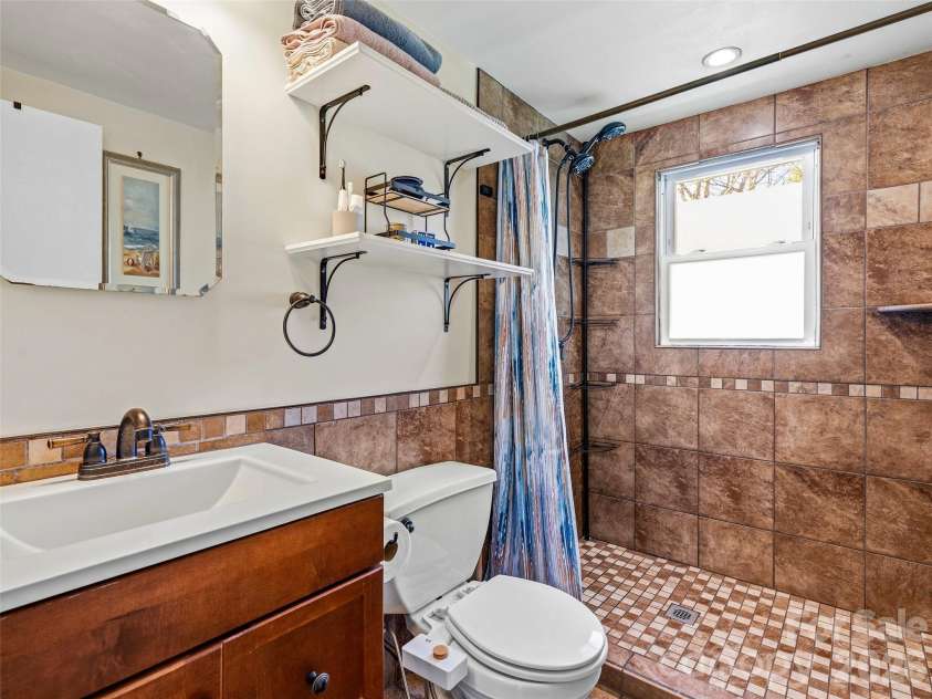 125 Lower Edgewood Road, Candler, NC 28715.  MLS# CAR4371013, YatesRealty ID 27557. Full bathroom recently renovated with gorgeous shower.