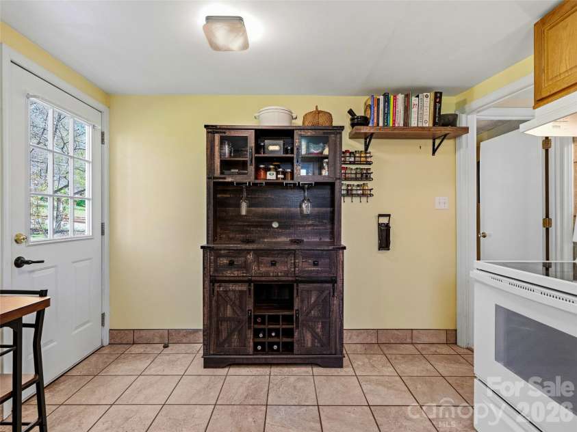 125 Lower Edgewood Road, Candler, NC 28715.  MLS# CAR4371013, YatesRealty ID 27557. Lovely tile floor in the kitchen.