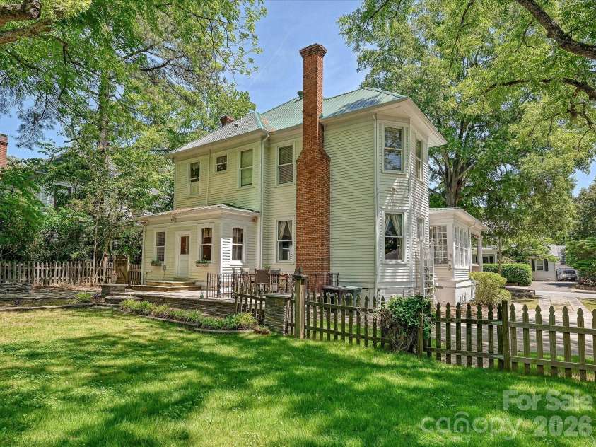 702 Hayne Street, Monroe, NC 28112.  MLS# CAR4376608, YatesRealty ID 27571. Classic exterior elevation showcasing enduring architectural character and generous outdoor space.