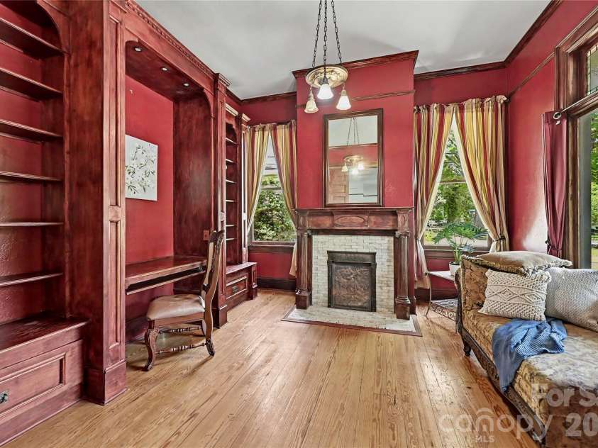 702 Hayne Street, Monroe, NC 28112.  MLS# CAR4376608, YatesRealty ID 27571. Distinguished study or library with custom built-ins, fireplace, and refined historic ambiance.