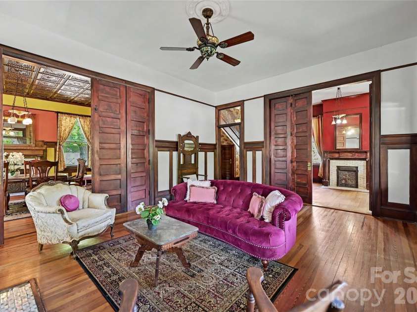702 Hayne Street, Monroe, NC 28112.  MLS# CAR4376608, YatesRealty ID 27571. Elegant parlor accented by rich woodwork, decorative fireplaces, and period details throughout.