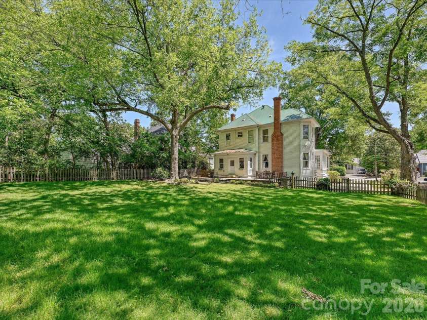 702 Hayne Street, Monroe, NC 28112.  MLS# CAR4376608, YatesRealty ID 27571. Exceptional grounds featuring mature landscaping and a stately historic presence.