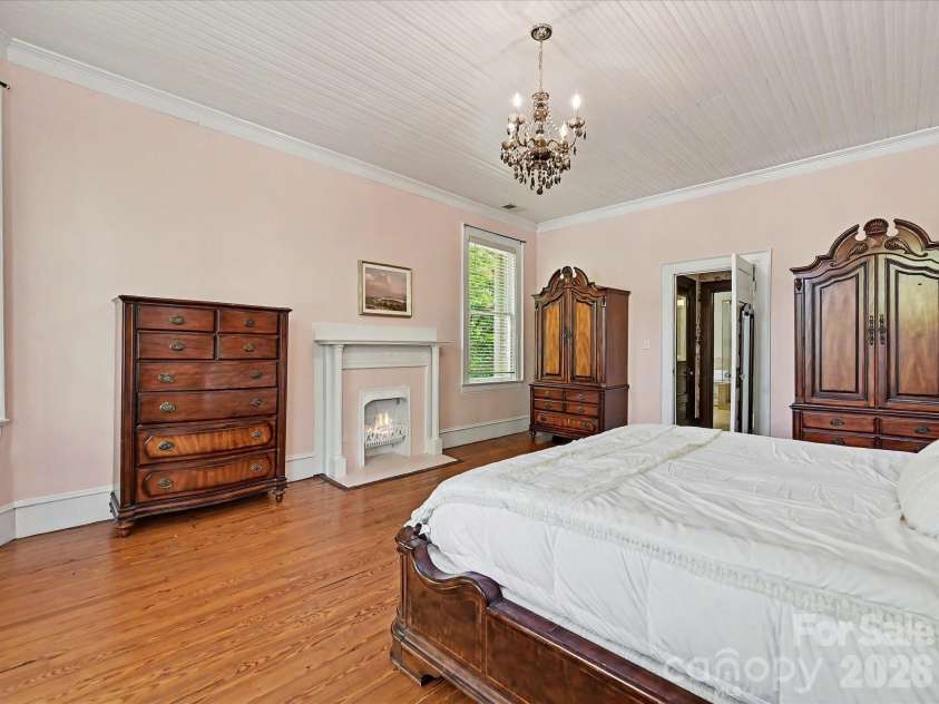 702 Hayne Street, Monroe, NC 28112.  MLS# CAR4376608, YatesRealty ID 27571. Expansive bedroom retreat featuring hardwood floors, decorative fireplace, and timeless character.