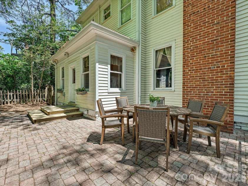 702 Hayne Street, Monroe, NC 28112.  MLS# CAR4376608, YatesRealty ID 27571. Expansive brick courtyard with historic charm and inviting outdoor gathering spaces.