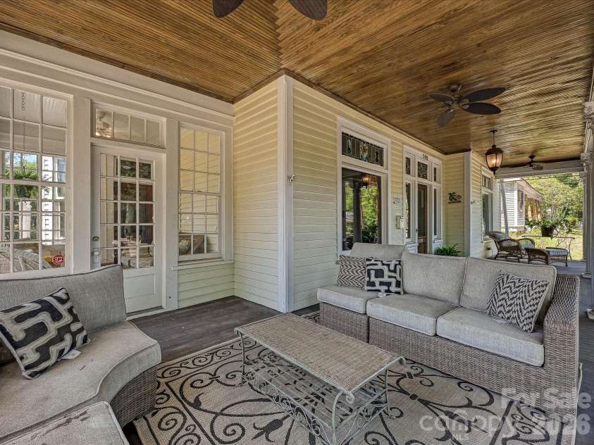 702 Hayne Street, Monroe, NC 28112.  MLS# CAR4376608, YatesRealty ID 27571. Expansive wraparound porch designed for relaxing afternoons and effortless entertaining.