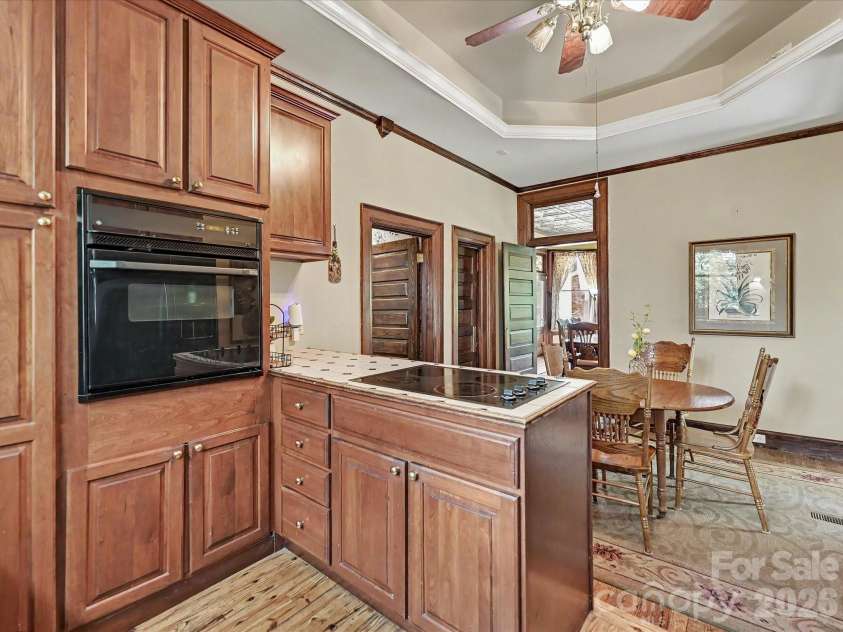 702 Hayne Street, Monroe, NC 28112.  MLS# CAR4376608, YatesRealty ID 27571. Functional center island and custom cabinetry create an inviting heart of the home.