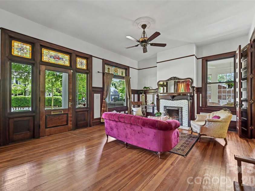 702 Hayne Street, Monroe, NC 28112.  MLS# CAR4376608, YatesRealty ID 27571. Light-filled sitting room with oversized windows and beautifully preserved historic character.