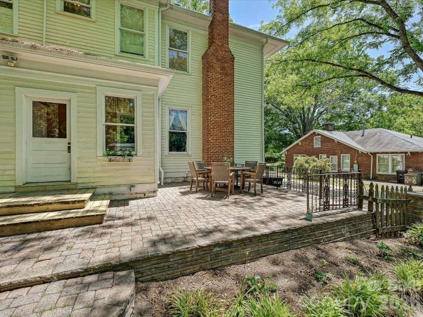 702 Hayne Street, Monroe, NC 28112.  MLS# CAR4376608, YatesRealty ID 27571. Private outdoor patio perfect for entertaining, dining, or relaxing under mature trees.