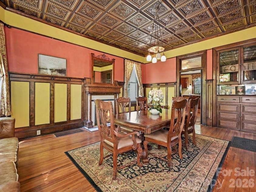 702 Hayne Street, Monroe, NC 28112.  MLS# CAR4376608, YatesRealty ID 27571. Stunning dining space with intricate millwork and beautifully preserved architectural detail.