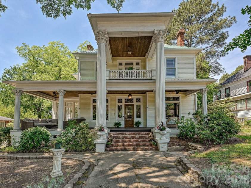 702 Hayne Street, Monroe, NC 28112.  MLS# CAR4376608, YatesRealty ID 27571. Timeless historic façade with grand wraparound porch and classic Southern architectural charm.