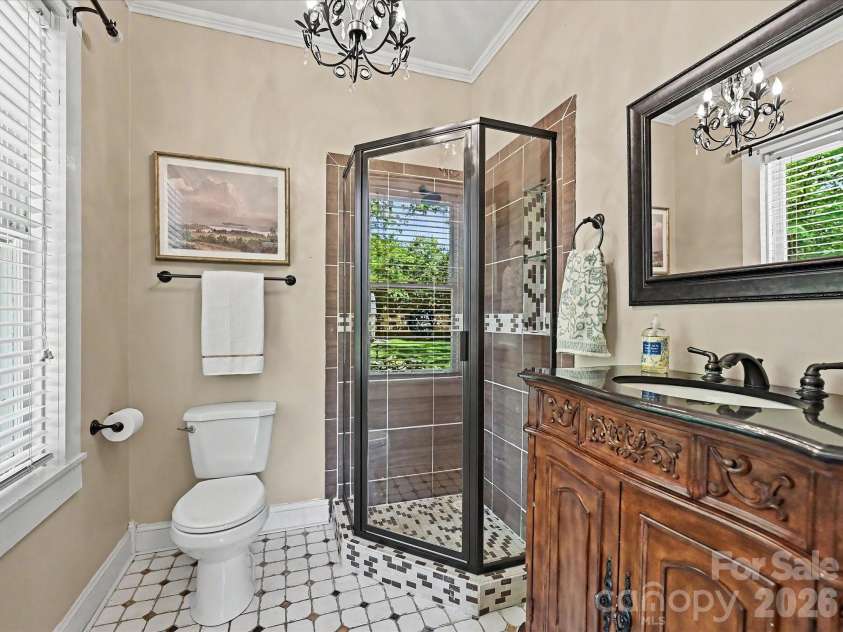 702 Hayne Street, Monroe, NC 28112.  MLS# CAR4376608, YatesRealty ID 27571. Updated bath featuring vintage-inspired finishes and beautifully crafted vanity details.