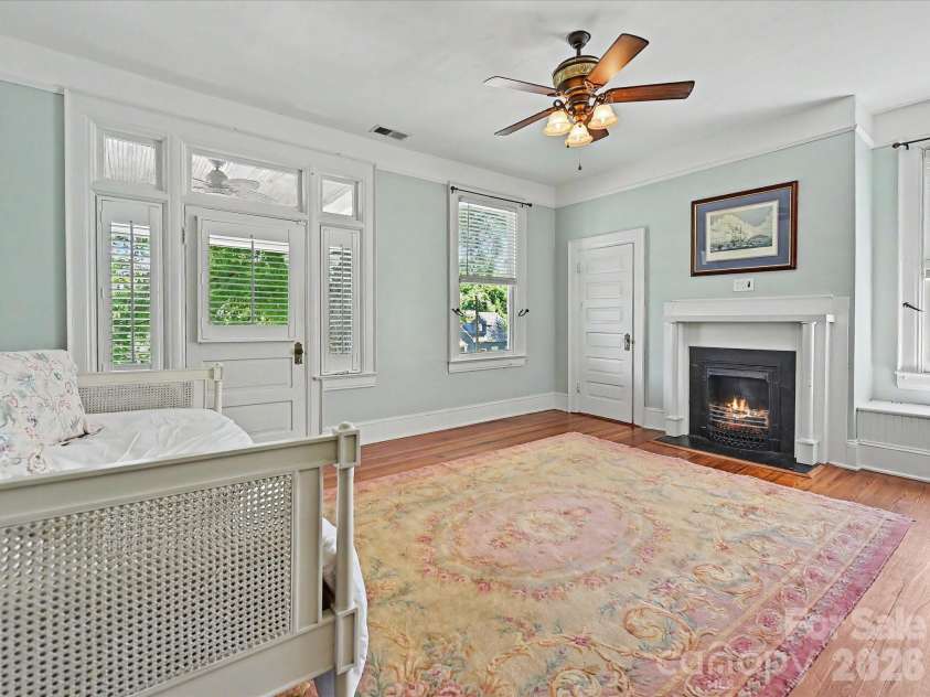702 Hayne Street, Monroe, NC 28112.  MLS# CAR4376608, YatesRealty ID 27571. Versatile upper-level living area with fireplace, abundant light, and flexible use potential.
