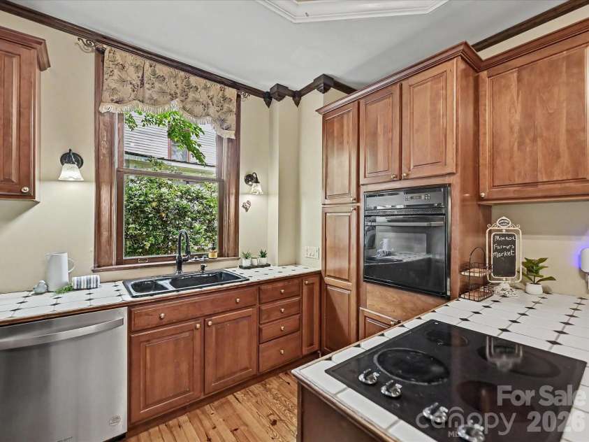 702 Hayne Street, Monroe, NC 28112.  MLS# CAR4376608, YatesRealty ID 27571. Well-appointed kitchen with classic cabinetry, generous prep space, and timeless appeal.