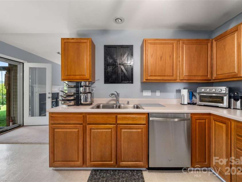 34 Dove Hollow Road, Fletcher, NC 28732.  MLS# CAR4279098, YatesRealty ID 27596. Kitchen with a glance of the views