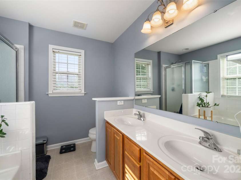 34 Dove Hollow Road, Fletcher, NC 28732.  MLS# CAR4279098, YatesRealty ID 27596. Primary Bath with double sink vanity and walk in shower