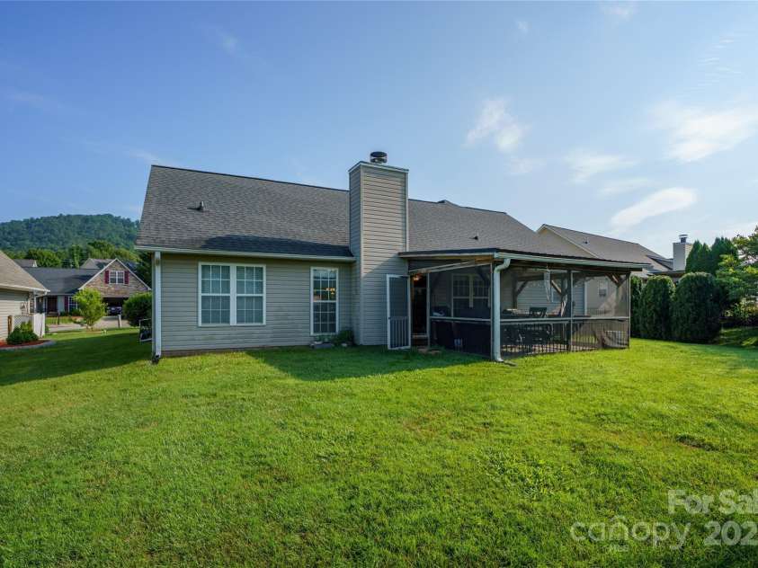 34 Dove Hollow Road, Fletcher, NC 28732.  MLS# CAR4279098, YatesRealty ID 27596. Rear elevation with level yard space and a peak of the views from the front of the home.