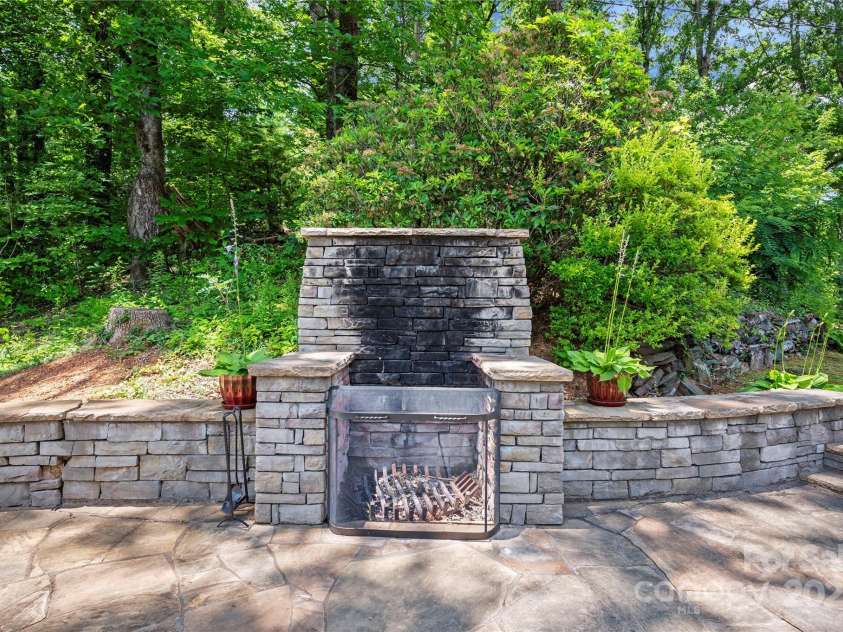 2045 Hogback Mountain Road, Tryon, NC 28782.  MLS# CAR4272415, YatesRealty ID 27598. Custom Stone fireplace-Terrace