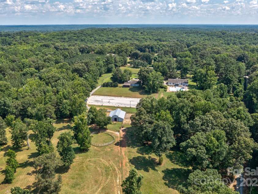 7411 Davis Road, Waxhaw, NC 28173.  MLS# CAR4278062, YatesRealty ID 27614. VIEW OF THE 3 LARGE PASTURES IN THE BACK OF THE BARN  nOTE ALL THE SHAFE TREES