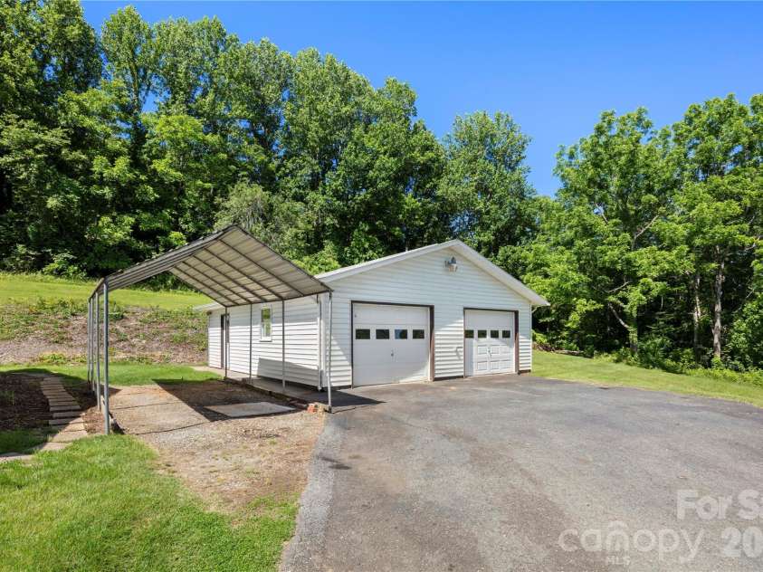 83 Honeysuckle Lane, Burnsville, NC 28714.  MLS# CAR4377930, YatesRealty ID 27630. Ample parking a flex space