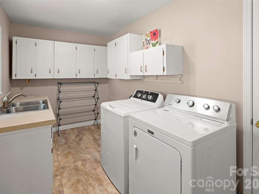 83 Honeysuckle Lane, Burnsville, NC 28714.  MLS# CAR4377930, YatesRealty ID 27630. Laundry room off kitchen with sink and ample storage