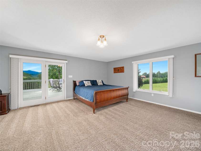 124 Dogwood Circle, Burnsville, NC 28714.  MLS# CAR4290145, YatesRealty ID 2764. Primary Bedroom with covered porch and decking connected 
