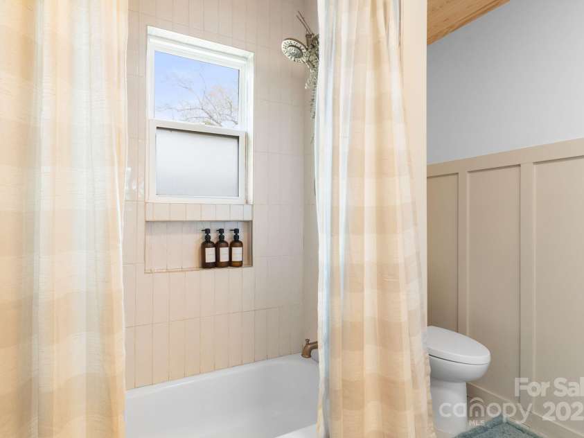 452 Old Hendersonville Highway, Brevard, NC 28712.  MLS# CAR4226407, YatesRealty ID 27652. The charming bathroom provides a bright and welcoming space to start your day