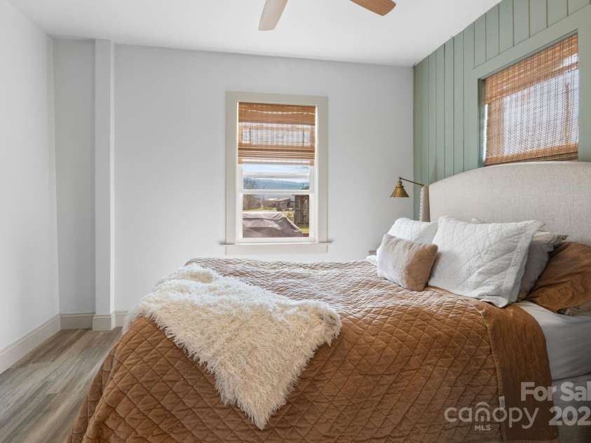 452 Old Hendersonville Highway, Brevard, NC 28712.  MLS# CAR4226407, YatesRealty ID 27652. The primary bedroom has a tasteful color palette and refined finishing touches, creating a serene retreat
