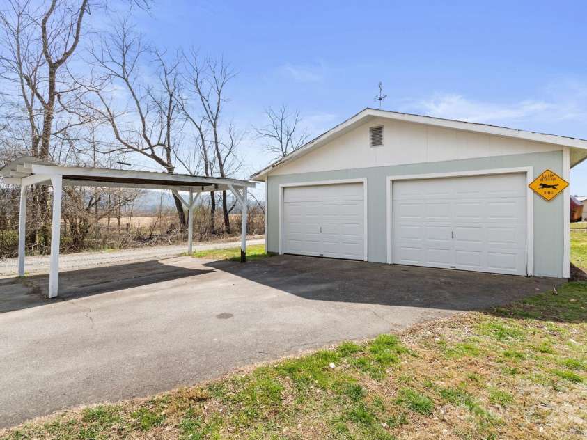 452 Old Hendersonville Highway, Brevard, NC 28712.  MLS# CAR4226407, YatesRealty ID 27652. This spacious two-car garage features brand-new doors, providing both style and security