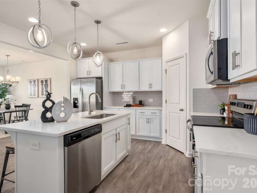 13205 Gadwal Pintail Drive, Charlotte, NC 28262.  MLS# CAR4380012, YatesRealty ID 27656. The center island showcases the beautiful quartz countertops.